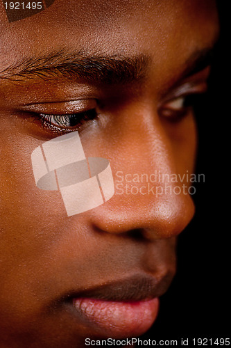 Image of young african man with dark skin looking