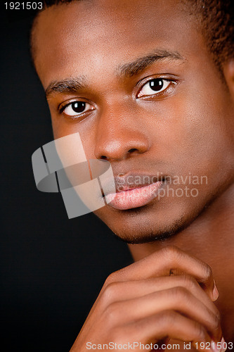 Image of young african man with dark skin looking