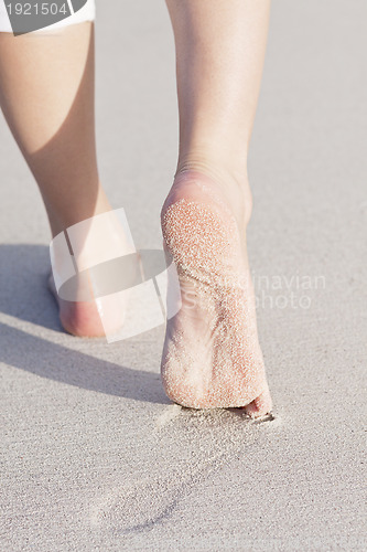 Image of barefoot in the sand in summer holidays