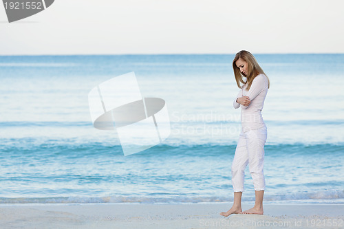 Image of beautiful blonde woman alone at the beach