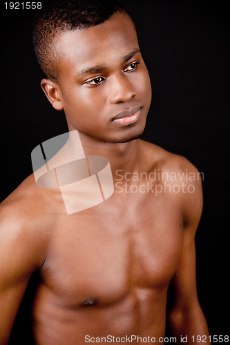 Image of young african man with dark skin looking