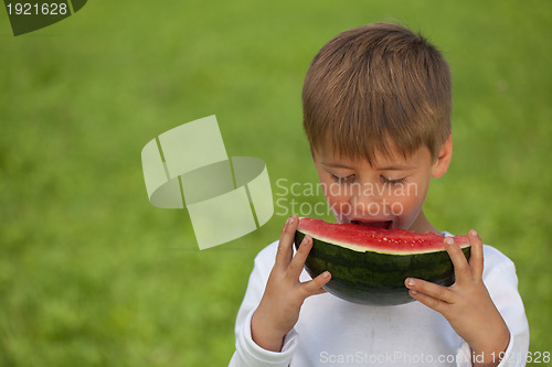 Image of Little boy eating a watermelon