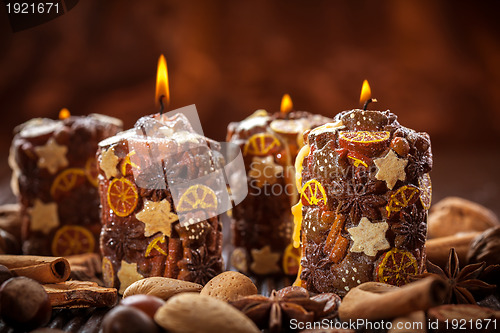 Image of Rustic Christmas candles with spices and  nuts