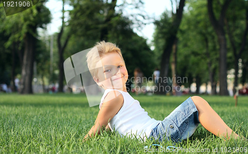 Image of Little boy sitting in the park