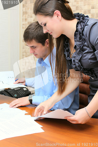 Image of Girl and man working in the office