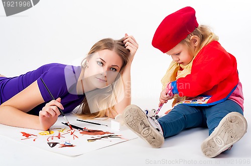 Image of Pretty young mother and daughter drawing