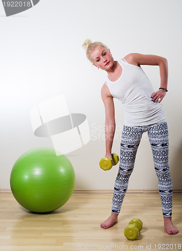Image of The young woman with pleasure is engaged in the health