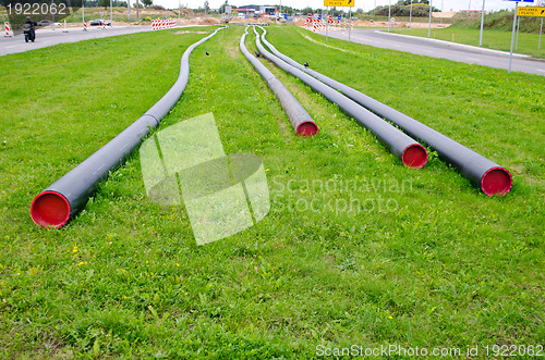 Image of electricity cable wire protective tube on meadow 