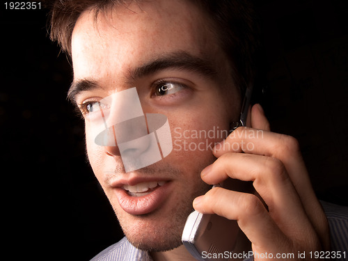 Image of Young man talking on cell phone
