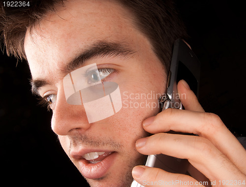 Image of Young man talking on cell phone