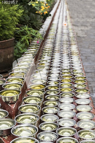 Image of small bowls with water around a temple