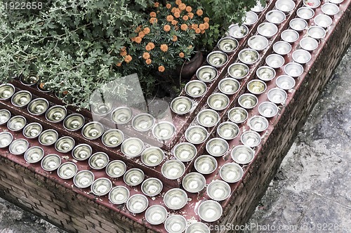 Image of small bowls with water around a temple