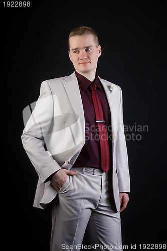 Image of attractive young man in suit and tie