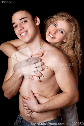 Image of Portrait of happy young couple. Isolated on black