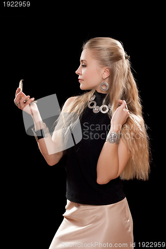 Image of lovely young woman with a mirror