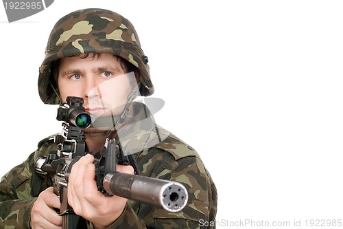 Image of Armed soldier pointing m16