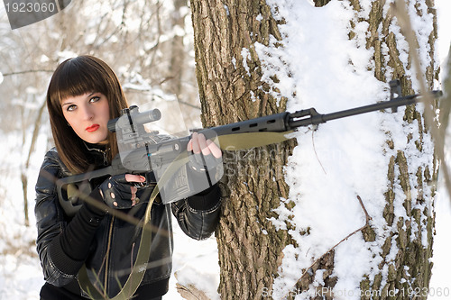 Image of lady with a sniper rifle 