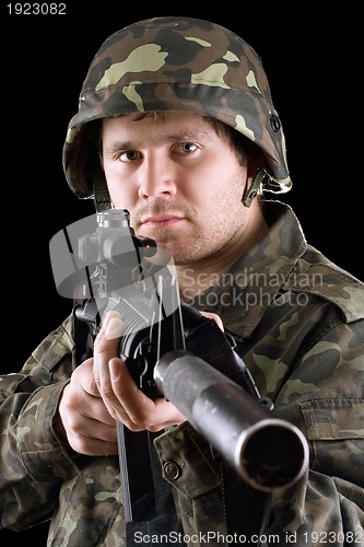 Image of Soldier holding a gun in studio