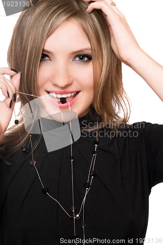 Image of Portrait of smiling girl with a bead in her mouth