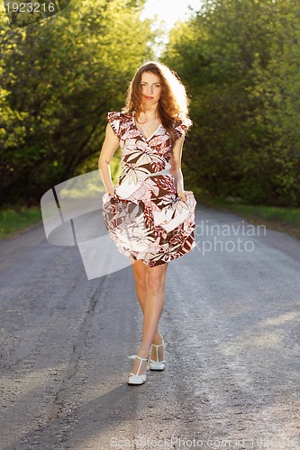 Image of Beautiful woman walking on the road