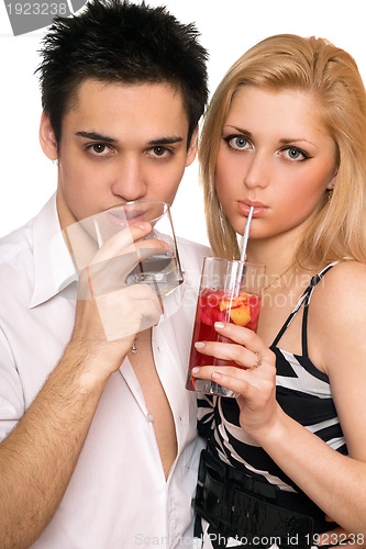 Image of Pretty young couple with cocktails. Isolated