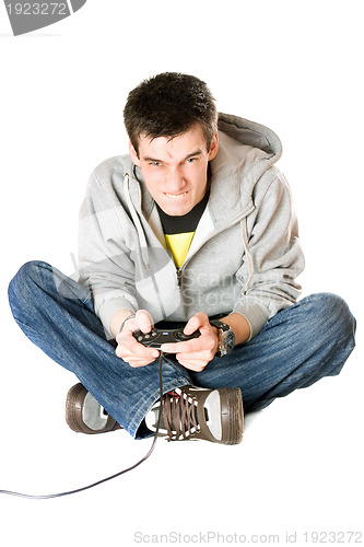 Image of Furious young man with a joystick for game console