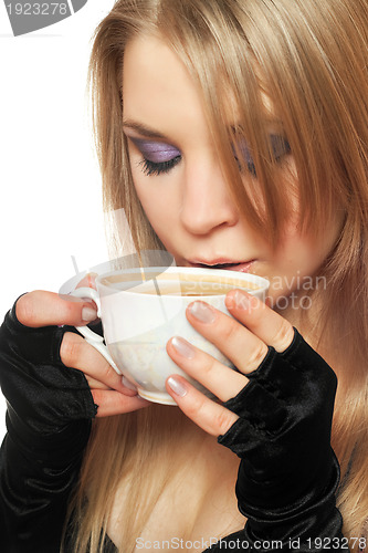 Image of Pretty young blonde with a cup of tea. Isolated