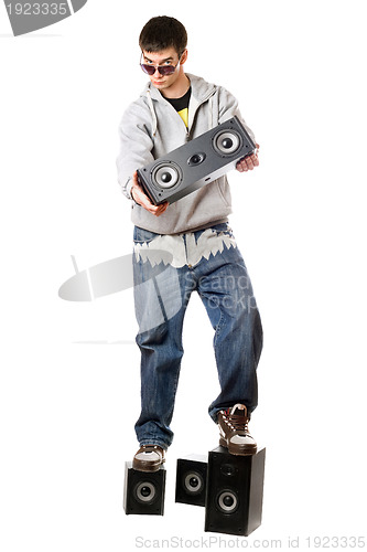 Image of Young man with a four speakers. Isolated 