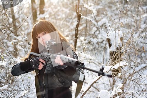 Image of Brunette girl aiming a gun