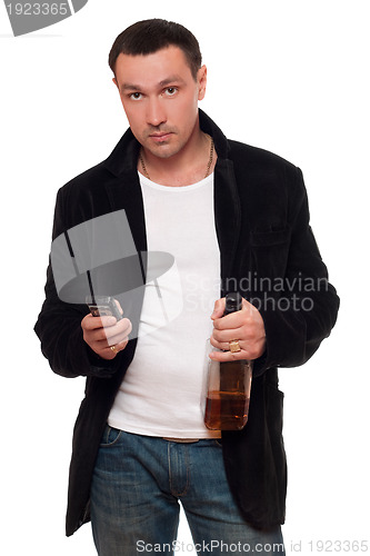 Image of Man with a phone and bottle of scotch