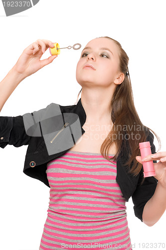 Image of Portrait of pretty young woman blow bubbles