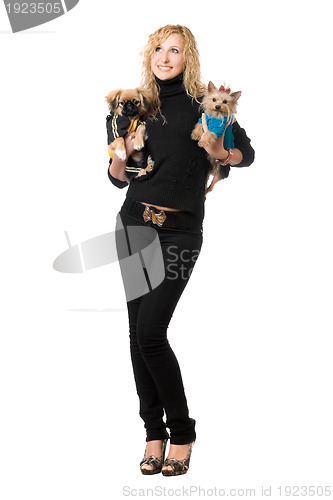 Image of Cheerful young blonde posing with two dogs