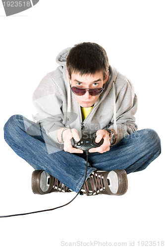 Image of Young man in sunglasses with a joystick