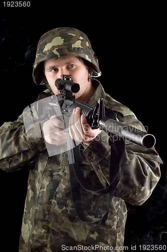 Image of Alerted soldier keeping a gun