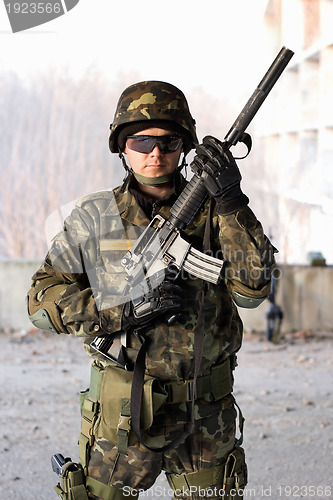 Image of Handsome guy holding a rifle