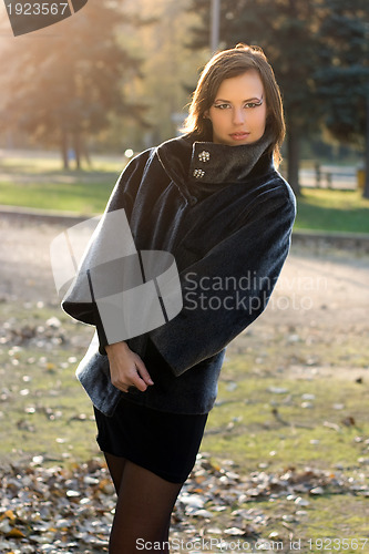 Image of gorgeous young woman in autumn park