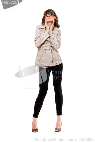 Image of Pretty girl wearing a coat and black leggings. Isolated