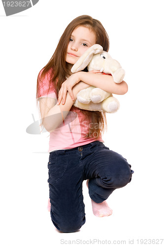 Image of Happy little girl with a teddy elephant