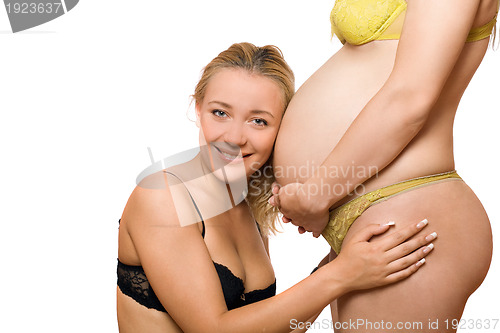 Image of Happy woman and belly of pregnant girlfriend