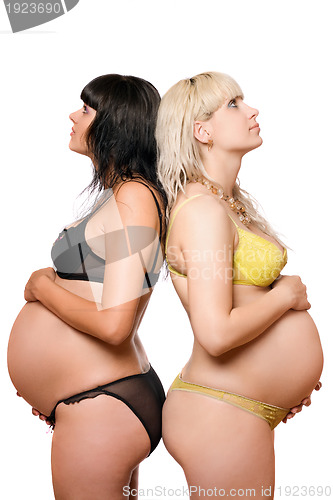 Image of Two pregnant young women. Isolated on white