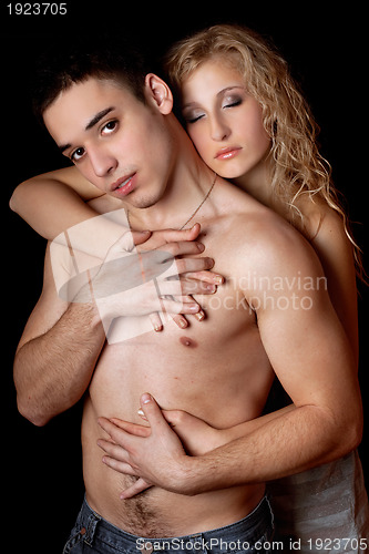 Image of Portrait of beautiful young couple. Isolated on black