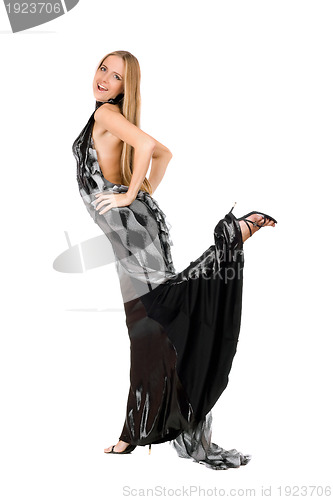 Image of Playful young woman in evening dress