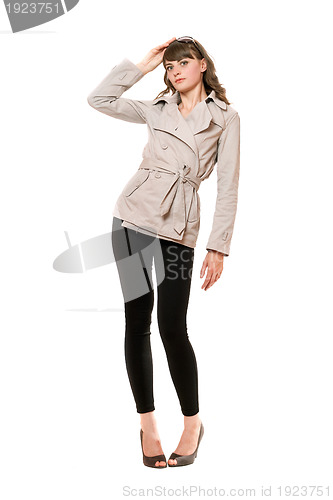 Image of Beautiful girl wearing a coat and black leggings. Isolated