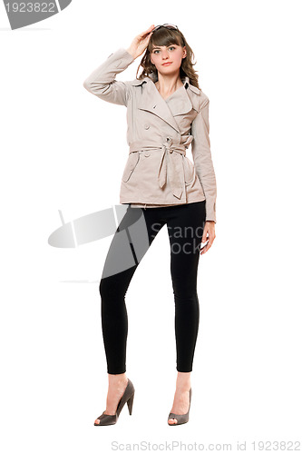 Image of Lovely girl wearing a coat and black leggings. Isolated