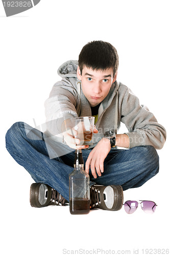 Image of Young man with a glass of whiskey