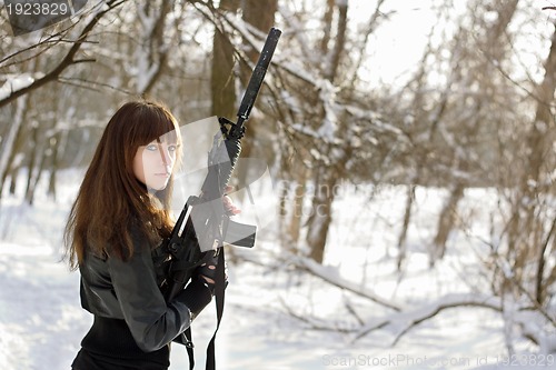 Image of Armed woman in the winter forest