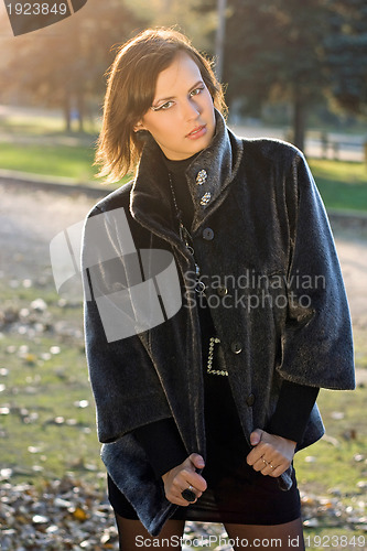 Image of lovely young woman in autumn park
