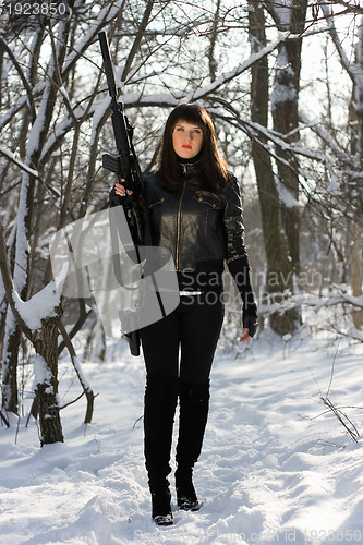 Image of Gorgeous young woman with a rifle