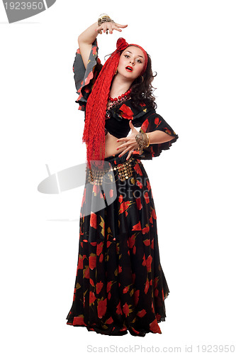Image of Expressive gypsy woman in a black skirt. Isolated