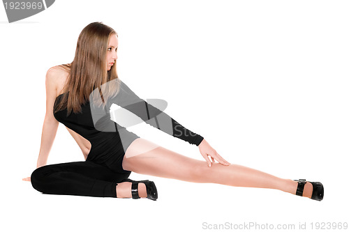 Image of Leggy young woman in a black tight-fitting body suit dance